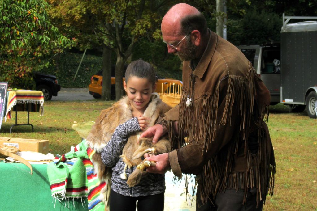 student playing with animal skins 